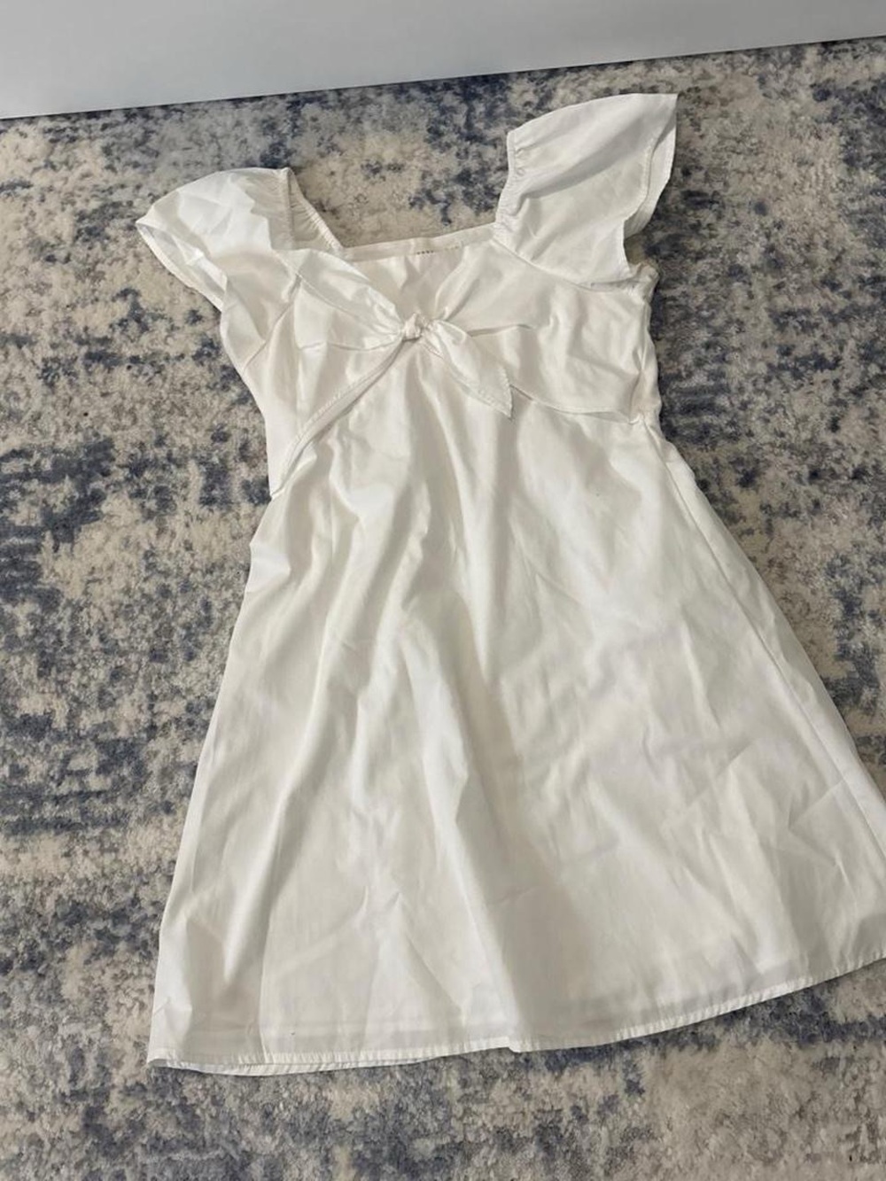 white babydoll dress with bow detail